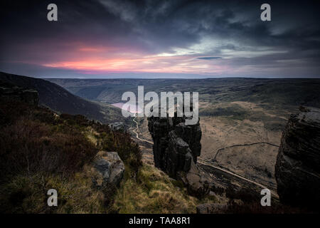 Sunset at The Trinnacle rock formation above Greenfield Reservoir near Dovestones, Peak District National Park, UK Stock Photo