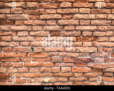 Weathered red brick wall texture, rustic background, Venice, Italy, rough masonry surface Stock Photo