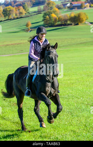 Woman riding out in falltime morning in bavarian Allgäu Stock Photo