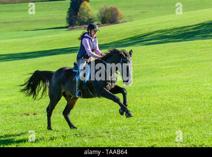 Woman riding out in falltime morning in bavarian Allgäu Stock Photo