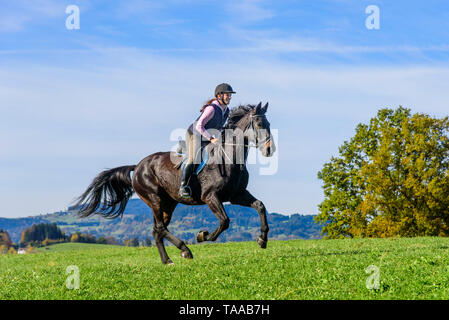 Woman riding out in falltime morning in bavarian Allgäu Stock Photo