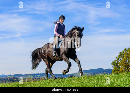 Woman riding out in falltime morning in bavarian Allgäu Stock Photo