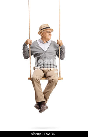 Full length portrait of a senior man sitting on a swing and looking away isolated on white background Stock Photo