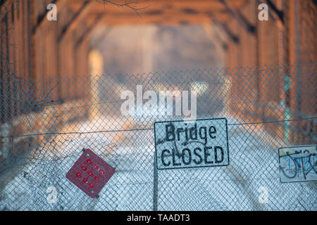 Bridge closed sign in front of dilapidated bridge Stock Photo