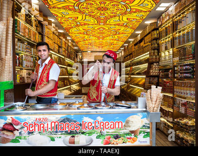ISTANBUL - MAY 23, 2016 - Young ice-cream sellers in the national red vest in the shop of Sultan Ahmed district Stock Photo