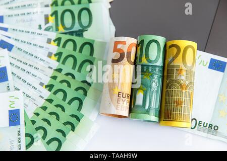 Banknotes of different denominations lie near the laptop Stock Photo