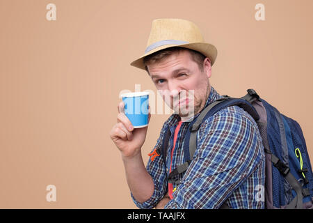 Young man wearing summer hat and holding cup Stock Photo