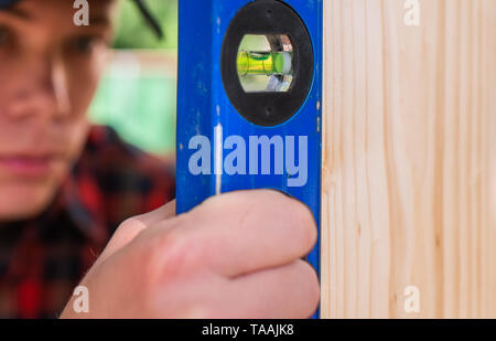 Young handsome man using water spirit level in his work Stock Photo