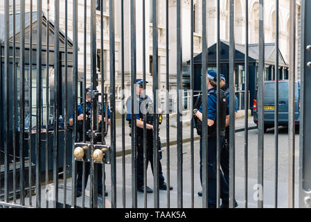 London, UK - May 14, 2019:  Police officers guarding 10 Downing Street entrance gate in the City of Westminster. 10 of Downing Street is the residence Stock Photo