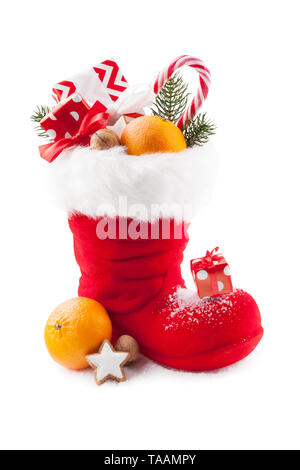 Santa boots with sweets and gifts on white background Stock Photo