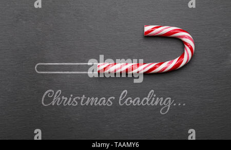 Christmas loading candy cane on blackboard Stock Photo