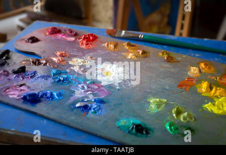 coloured oils on artists palette Stock Photo