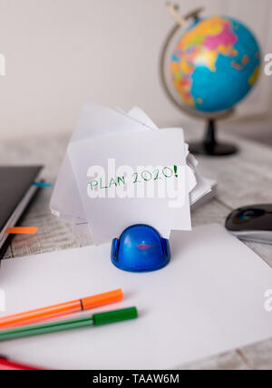 Word writing text Plan 2020. Business photo showcasing detailed proposal for doing or achieving something next year Stationary and computer stuff plus Stock Photo