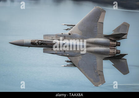 USAF F-15E Strike Eagle flying low level through the Mach Loop in Wales, UK Stock Photo