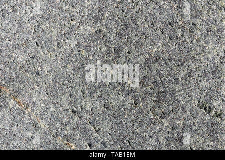 Closeup macro view of grey rough stone surface. Detailed nature pattern texture or background taken in natural environment. Weathered over years, uniq Stock Photo