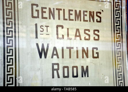 Old fashioned sign for 'Gentlemens' 1st Class Waiting Room' in a window on a platform at the railway station in Bolton, Lancashire Stock Photo