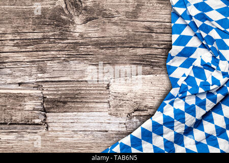 blue checkered bavarian tablecloth on a wooden table Stock Photo