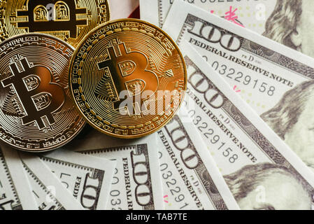 real bitcoins with a value higher than hundreds of dollars in bills. Stock Photo