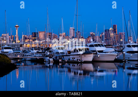 Retro image of Seattle skyline at Elliott Bay marina with boats moored with sunset light.