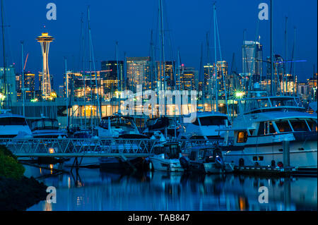 Retro image of Seattle skyline at Elliott Bay marina with boats moored with sunset light.