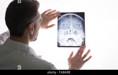 doctor examining patients x-ray and MRI scans. Human Head Sinusitis Stock Photo