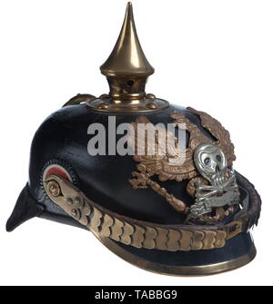 An Imperial German helmet M 1895 for enlisted men of Brunswick 92nd Infantry Regiment Large size leather body showing some crazing, black leather sweatband, brass line 'Fuerst' eagle with bright silver skull, crossbones and 'PENINSULA' banner, front plate attached by loops with leather straps, brass fittings, spike, base, spline and visor trim. Flat brass chinstraps with 91 lugs, EM national and Brunswick state cockades. USA-lot, see page 4. historic, historical, Braunschweig, Brunswick, German, Germany, Northern Germany, the North of Germany, ob, Additional-Rights-Clearance-Info-Not-Available Stock Photo