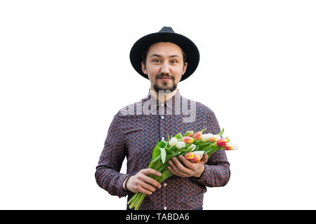 Portrait of a handsome young man with tulip flowers. Concept of a man holding tulip flowers as a gift for a special occasion isolated on white backgro Stock Photo