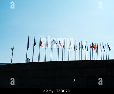 Side view of European union member flags waving and surveillance CCTV camera in front of the Parliament days before Parliamentary elections on 26 may  Stock Photo