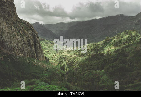 High angle view of a rugged valley below nestled in mountains. Stock Photo