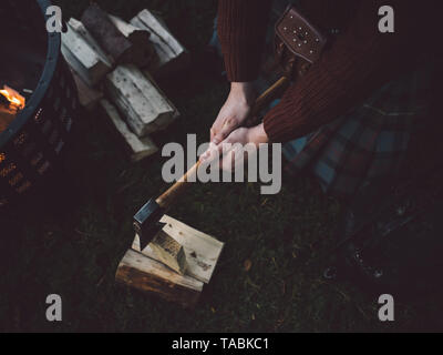 High angle view of man chopping wood with an ax. Stock Photo
