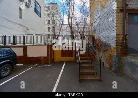 Moscow, Russia - March 23, 2019: Houses on Arbat street. White sign with russian text on the right house: The object is guarded by a private security  Stock Photo