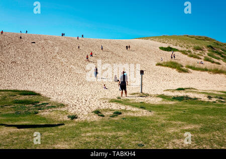 Dune Climb; high sand dune; people walking, strenuous exercise; Sleeping Bear Dunes National Lakeshore; Michigan; Empire; MI; summer; horizontal Stock Photo