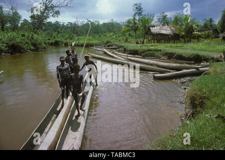 Asmat people: ethnic group living in the Papua province of Indonesia, along the Arafura Sea.  Young boys and canoes, village of Pirien. Photograph tak Stock Photo