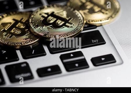 Crypto currencies buying and selling. Computer keyboard with Bitcoin coins on in. Buying and investing in digital currencies. Stock Photo