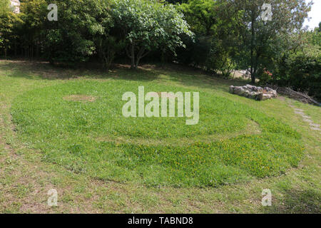 South of France - eco-friendly garden - healthy organic natural lawn - with a lawnmower - giant green grass emoji - smiley face - happy smiling Stock Photo