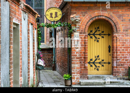 Riga, Latvia, May 02: A cozy and quiet courtyard surrounded by red brick houses in the old part of Riga, May 02, 2019. Stock Photo