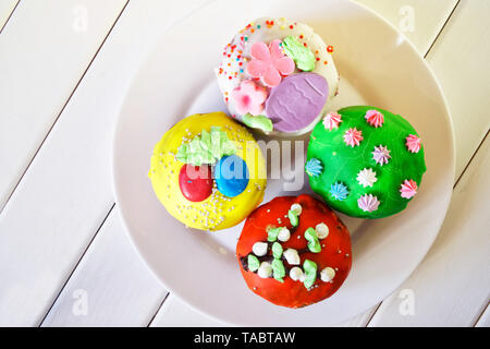 Delicious, colorful cupcakes - Easter cakes on a white plate. Homemade. Daylight. View from above Stock Photo