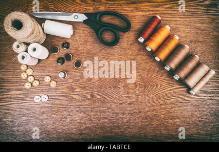 Sewing concept. Scissors, threads and buttons. Stock Photo