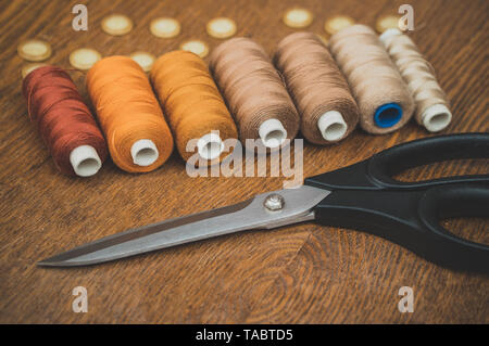 Sewing concept. Scissors, threads and buttons. Stock Photo