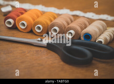 Sewing concept. Scissors and thread spools. Stock Photo