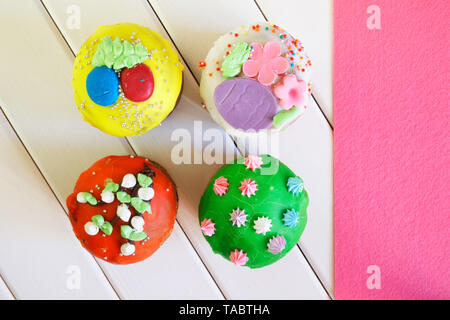 Colorful varied cupcakes - Easter cakes on white and pink background. Country breakfast. Homemade. Daylight. View from above Stock Photo