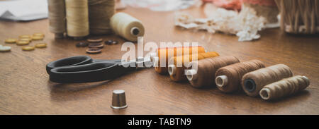 Sewing concept. Scissors, threads and buttons. Stock Photo