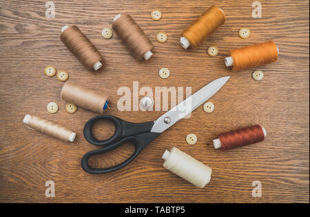 Sewing concept. Scissors, threads and buttons. Stock Photo