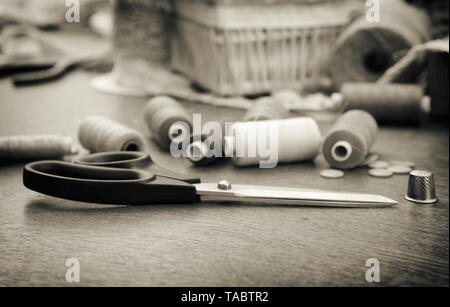 Sewing concept. Scissors, threads and buttons. Black and white. Stock Photo
