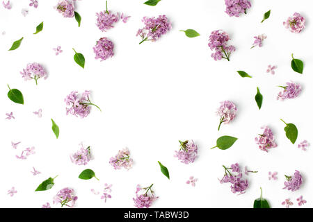 frame with leaves and lilac petals on white background. flat lay, overhead view Stock Photo