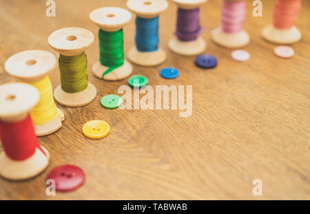 Sewing concept. Colorful buttons and thread spools. Stock Photo