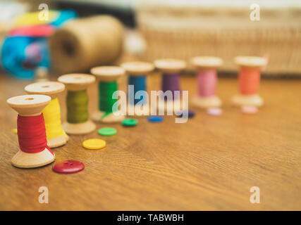 Sewing concept. Colorful buttons and thread spools. Stock Photo