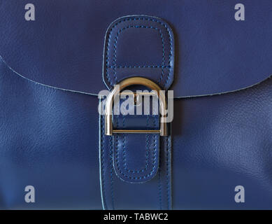 Large coarse buckle on a blue leather bag made of genuine leather close-up Stock Photo