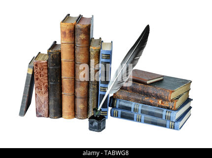 Several old books, quill and the inkwell isolated on a white background Stock Photo