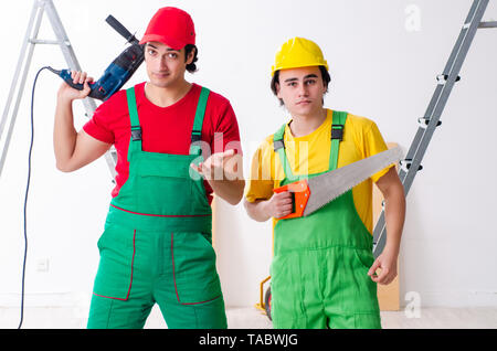 Two workers contractors working indoors Stock Photo